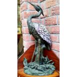 A large Tiffany style table lamp in the form of a heron, Verdigris effect base with amethyst