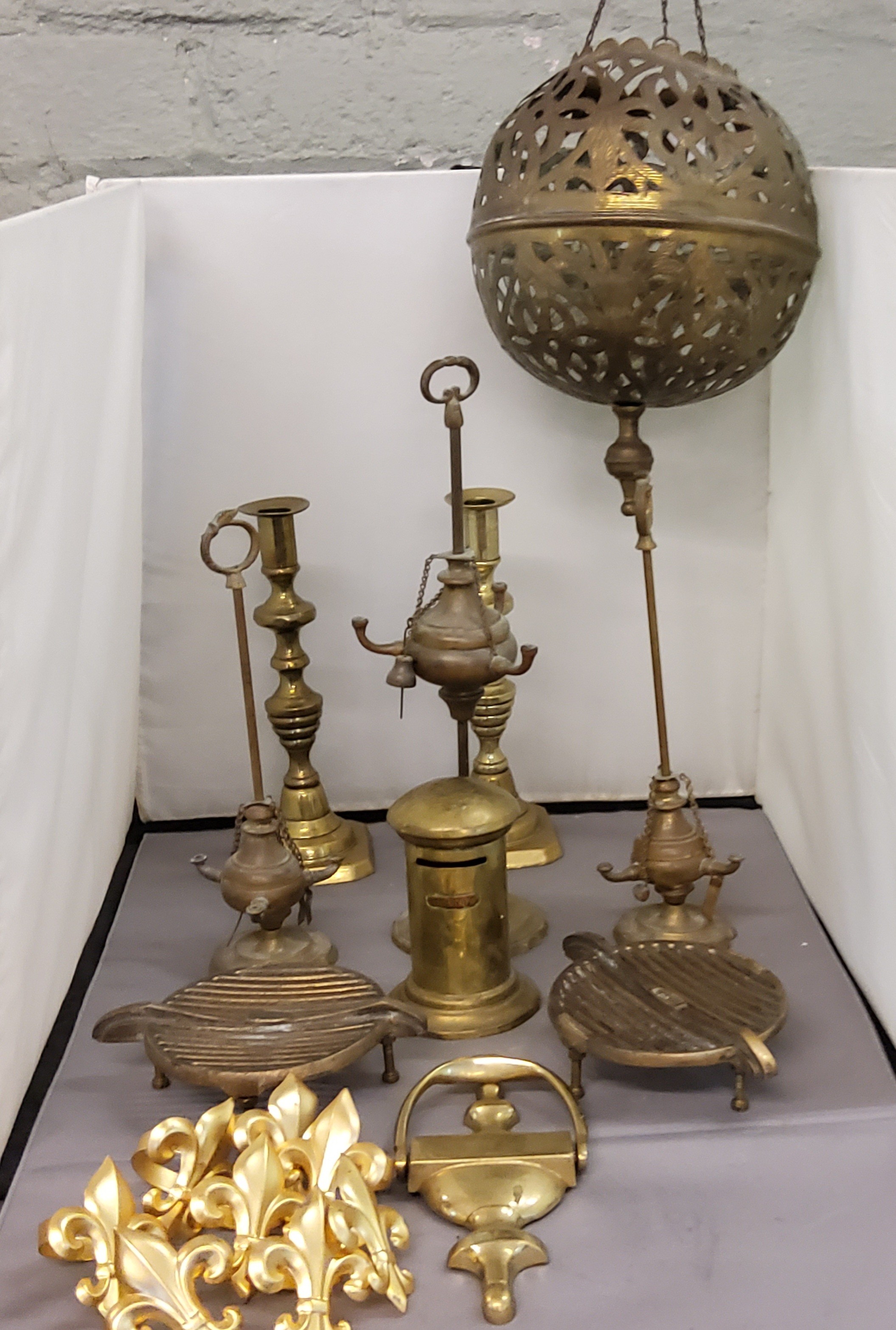 A Persian brass pierced globular ceiling lantern;  three Eastern adjustable oil lamps;  a pair of