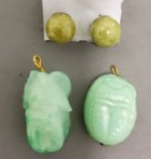 A pair of Jade ear studs;  a Jade scarab pendant;  another  (3)
