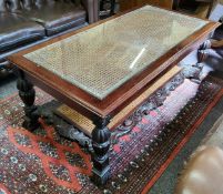 A 20th century mahogany glass topped coffee table, rattan inset panels with acanthus carved