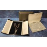 A graduated pearl necklace, 9ct gold clasp, original box; a contemporary multi link knot necklace in
