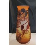 An Art Glass ovoid vase, etched with pine tree and cones, in red on a mottled yellow ground, bears
