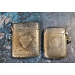 A silver bowed rectangular vesta case, engraved and chased with foliate scrolls, raised shield