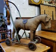 Juvenalia - A 1920's / 30's straw filled push along donkey/horse child's toy, leather capped hooves,