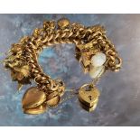 A Victorian 9ct rose gold hollow curb charm bracelet, embossed in relief decoration, 15 charms