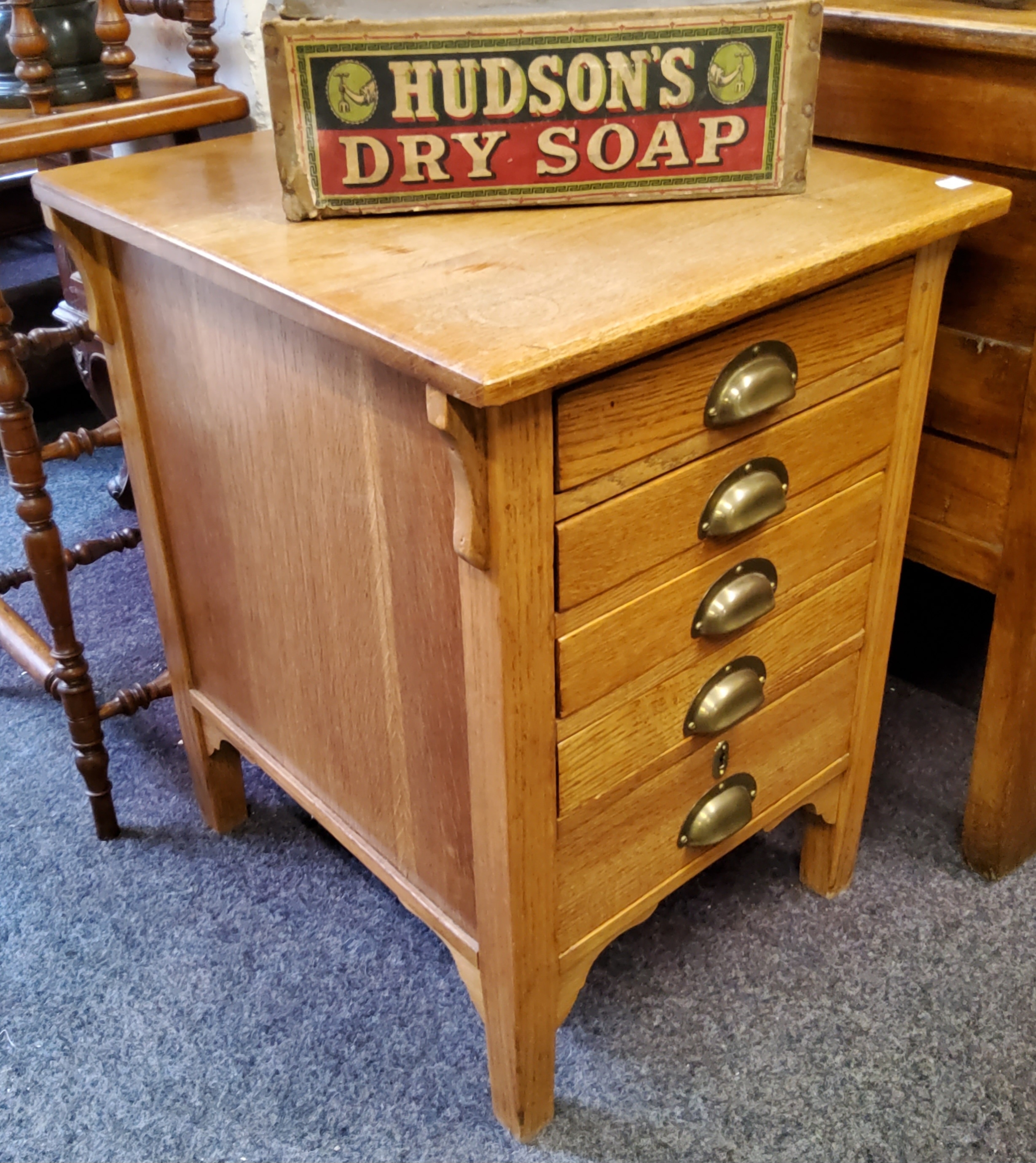 An early 20th century light oak deep bank of five drawers, brass cup handles stamped 'GR' for