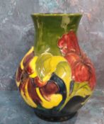 A Moorcroft Hibiscus pattern baluster vase, tube lined with large flowerheads,  in tones of red on a