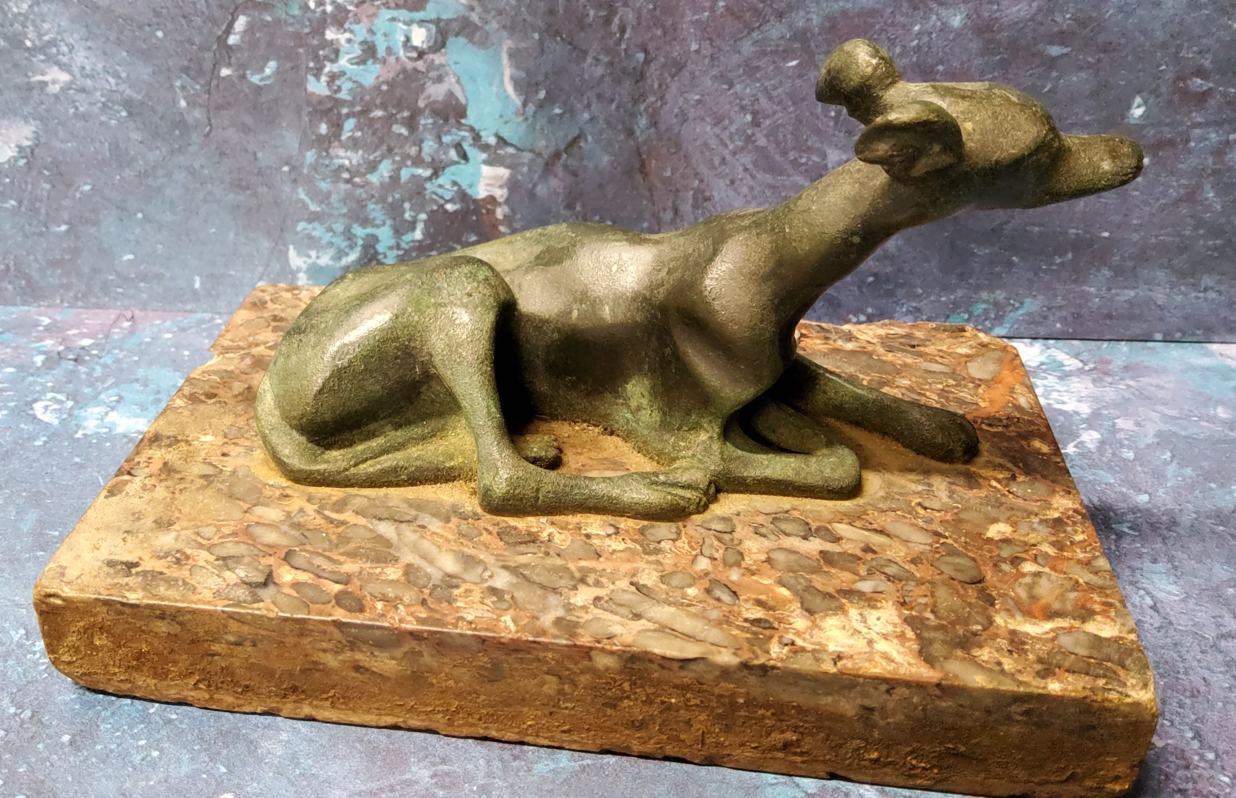 A 19th century green patinated bronze model, of a reclining greyhound, rectangular marble base, 14cm