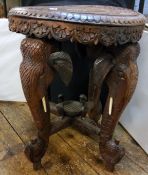 An African hardwood table, each of the legs, with elephant, bone tusks, 38cm diam, 49cm high