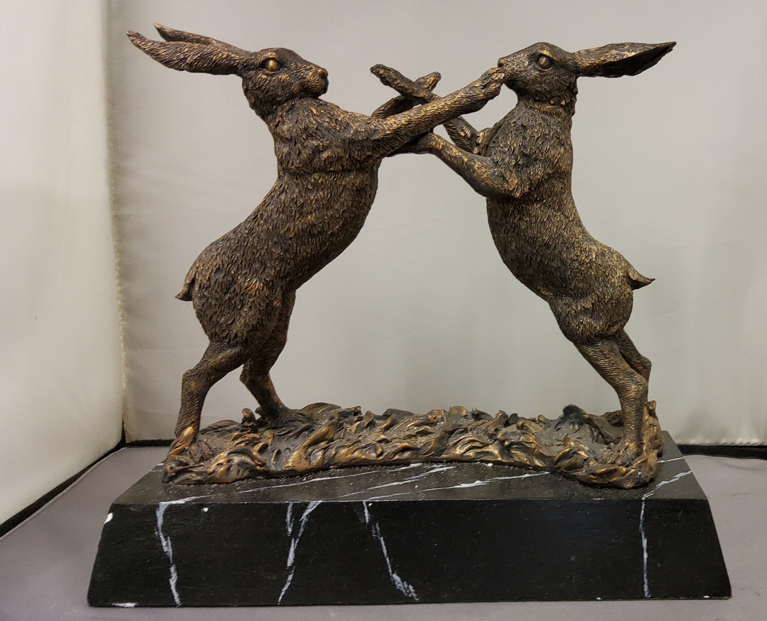 Libra Company, bronzed resin, Hares Boxing, faux black marble base, 23cm high