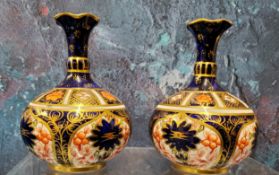 A pair of Royal Crown Derby 1128 pattern bottle vases, 8.5cm high, printed marks, printed mark, date