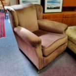 Victorian Howard & Sons style deep armchair (lacking one brass castor)