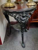 A Coalbrookdale style cast iron pub table with lion mask and caryatid capped cabriole legs with
