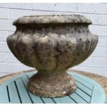 A reconstituted stone urn shaped planter