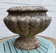 A reconstituted stone urn shaped planter