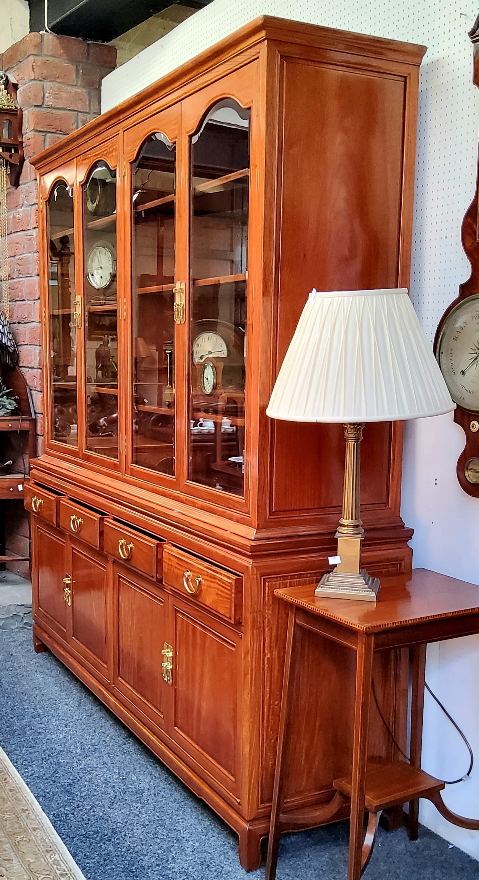 A Chinese hardwood mirrored back display cabinet, glazed doors with toughened glass shelves, 177cm