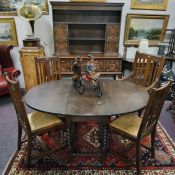 An oak dining room suite, including barley twist drop leaf dining table with four matching chairs (