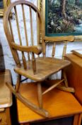A child's beech spindle back rocking chair