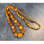 A 86cm string of oval butterscotch amber beads, total weight 50.7g