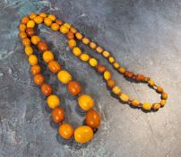 A 86cm string of oval butterscotch amber beads, total weight 50.7g