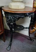 A Coalbrookdale style cast pub table by Freegate Metals with lion and female mask capped supports,