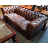 A three seater Chesterfield sofa (later wooden feet)