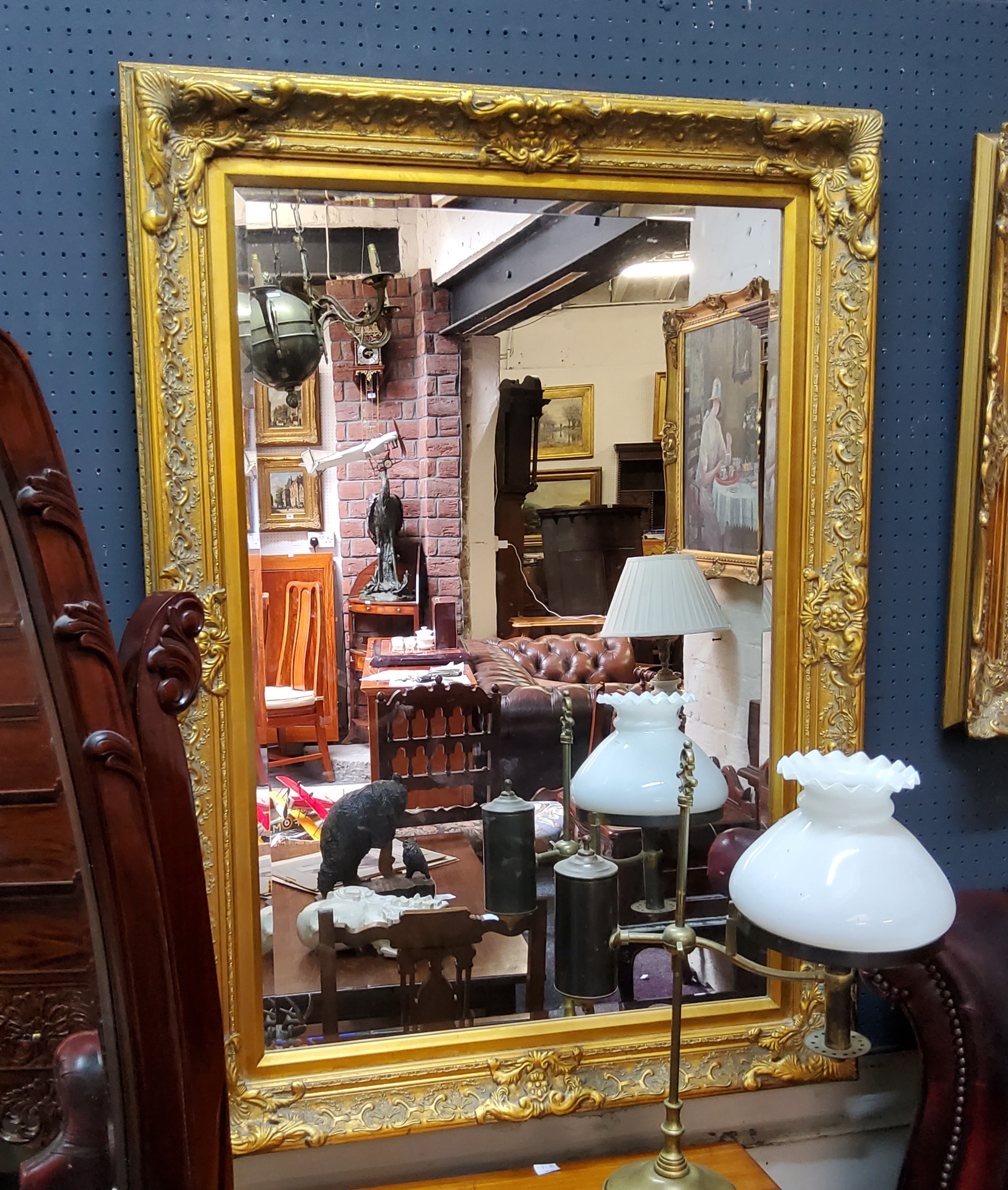 A decorative gilt framed bevelled edge mirror, 111cm high x 80cm wide