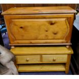 A modern golden oak rounded rectangular coffee table; a pine toy chest (2)