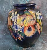 A large Moorcorft Iris pattern ovoid vase, tube lined with large flowerheads in tones of red,