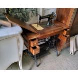 An early 20th century Singer sewing machine trestle table