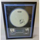 Robbie Williams a signed framed drum skin mounted with images and title, certificate of authenticity