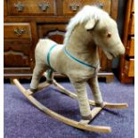 An early / mid 20th century child's rocking horse, corduroy and leather (lacking one eye)
