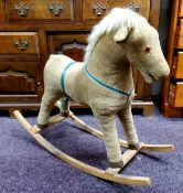 An early / mid 20th century child's rocking horse, corduroy and leather (lacking one eye)