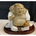 A 20th century Chinese figure, of a seated Buddha, 11.5cm high, hardwood base