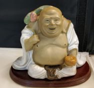 A 20th century Chinese figure, of a seated Buddha, 11.5cm high, hardwood base