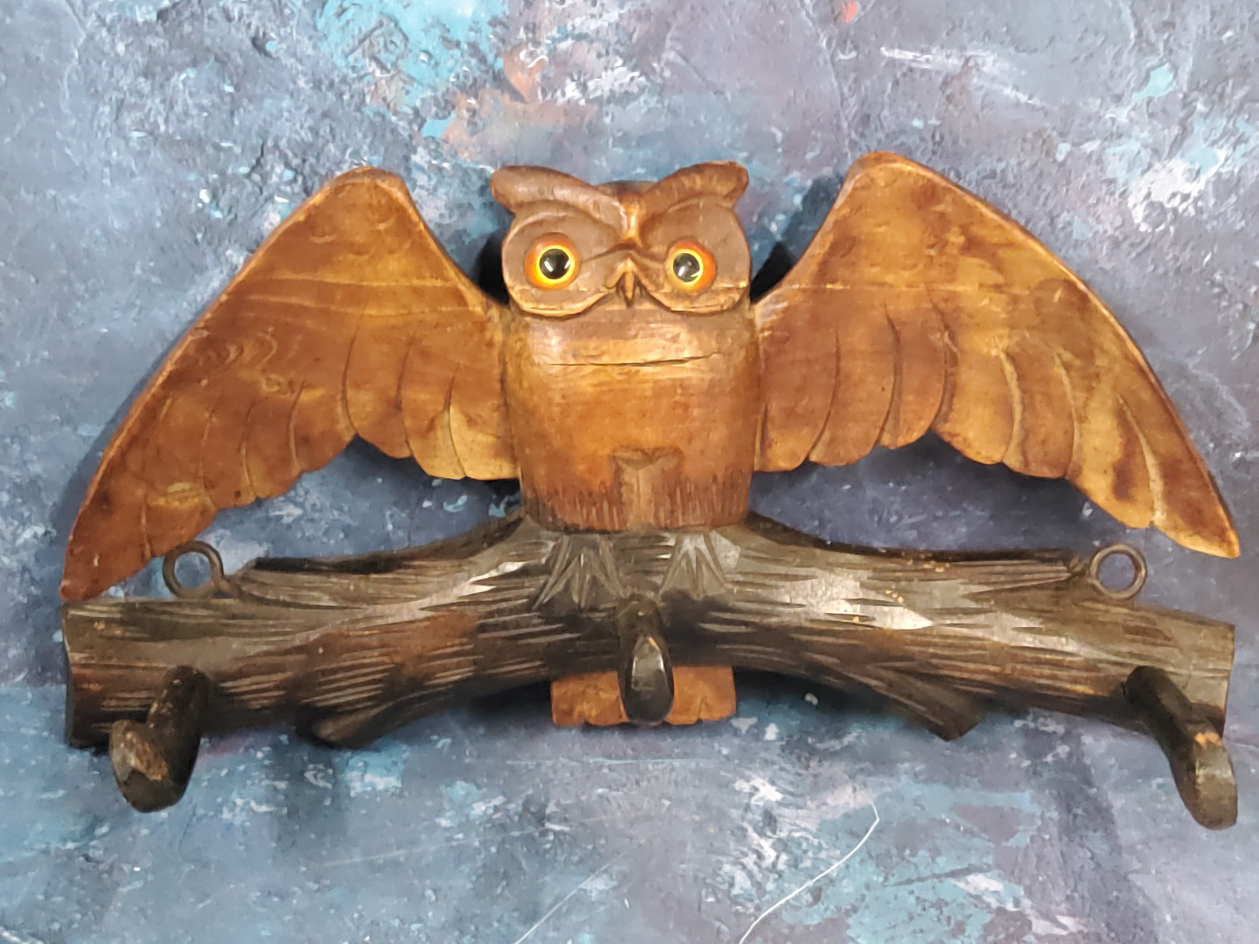 A Victorian novelty coat book, carved with an owl with wings outstretched, three hooks, 32cm wide