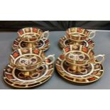 A set of four Royal Crown Derby 1128 pattern pedestal teacups and saucers, printed marks