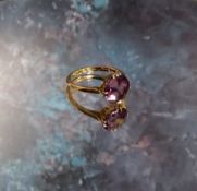An 18ct gold dress ring, claw set with a round amethyst,  (3.25g gross weight)