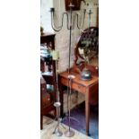 A patinated wrought iron freestanding candelabra and other metal candle stands (4)