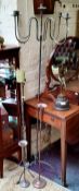 A patinated wrought iron freestanding candelabra and other metal candle stands (4)