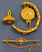 A lady's 9ct gold plated watch;  a gold coloured metal fob, purple stone;  a gold coloured metal