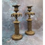 A pair of 19th century bronze Gothic Revival candlesticks, pierced everted foliate sconces, the