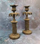 A pair of 19th century bronze Gothic Revival candlesticks, pierced everted foliate sconces, the