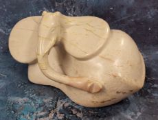 An unusual tribal carved hardstone elephant, over exaggerated ears and trunk