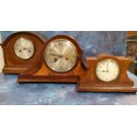 A 20th century mantel clock, the case inlaid with scrolls, Arabic numerals, twin winding holes, 45cm