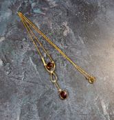 An Edwardian yellow metal garnet and seed pearl drop pendant necklace, indistinctly marked (3.2g