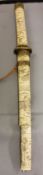 A Japanese bone tanto, 31cm blade, gilt metal tsuba, tsuka and saya profusely carved with figures,