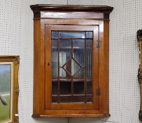 A 19th century oak astragal glazed corner cupboard, dental cornice, later added mirror tiled back