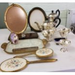 A four-piece E.P.N.S. tea service, paneled sides, c.1940;  a gilt metal mounted dressing table set;