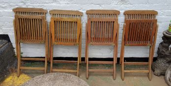 Four teak garden chairs